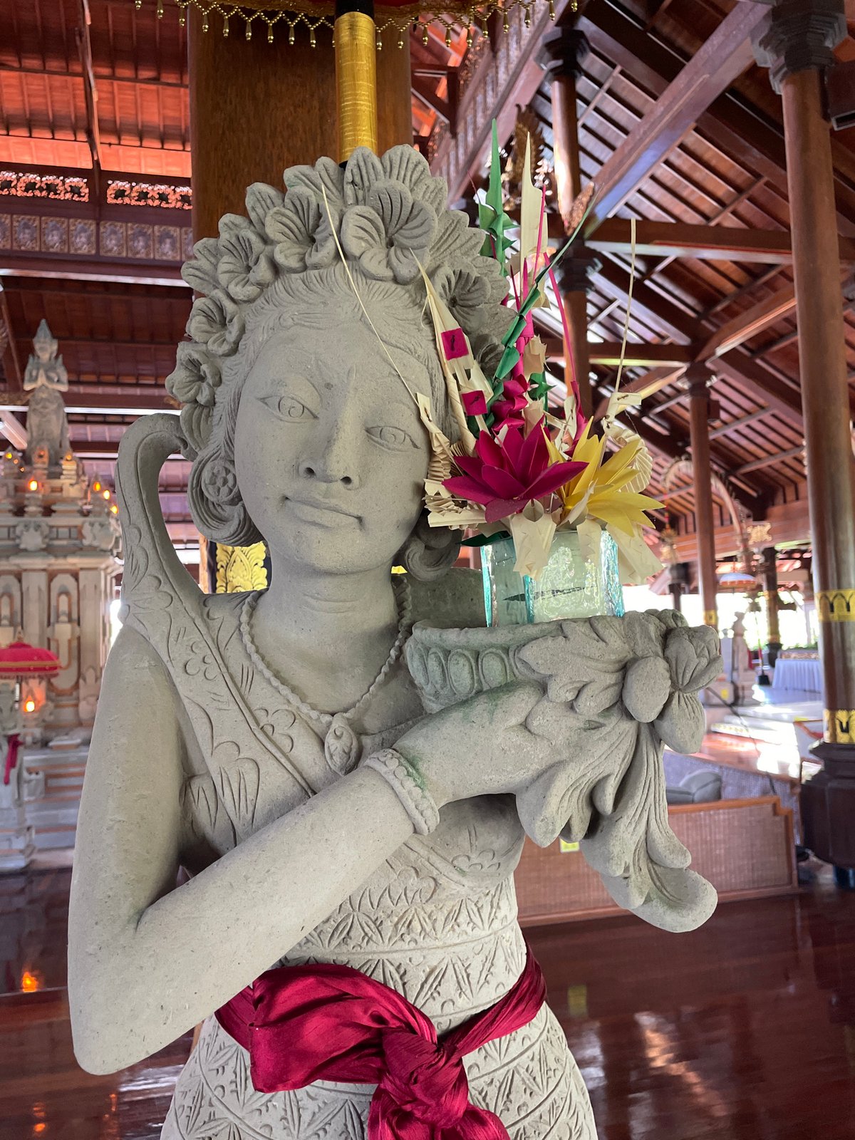 Witness documents Balinese temple complex with statues, masks, koi
