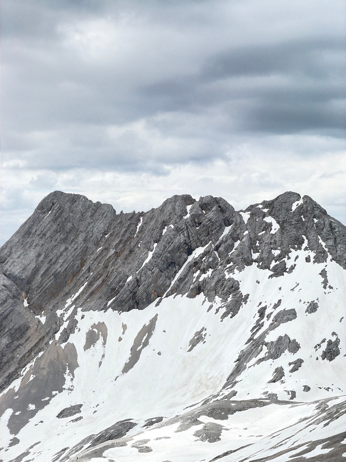 Snow, rock, and shelf jars at Zugspitze on a cloudy morning