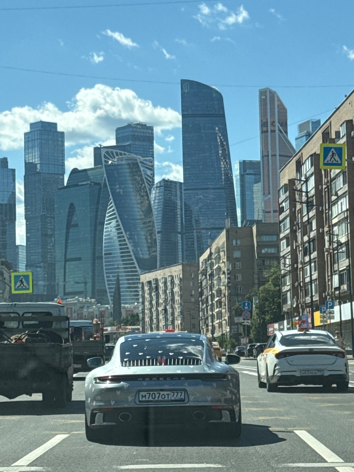 Silver Porsche 911 cruising through Moscow city streets