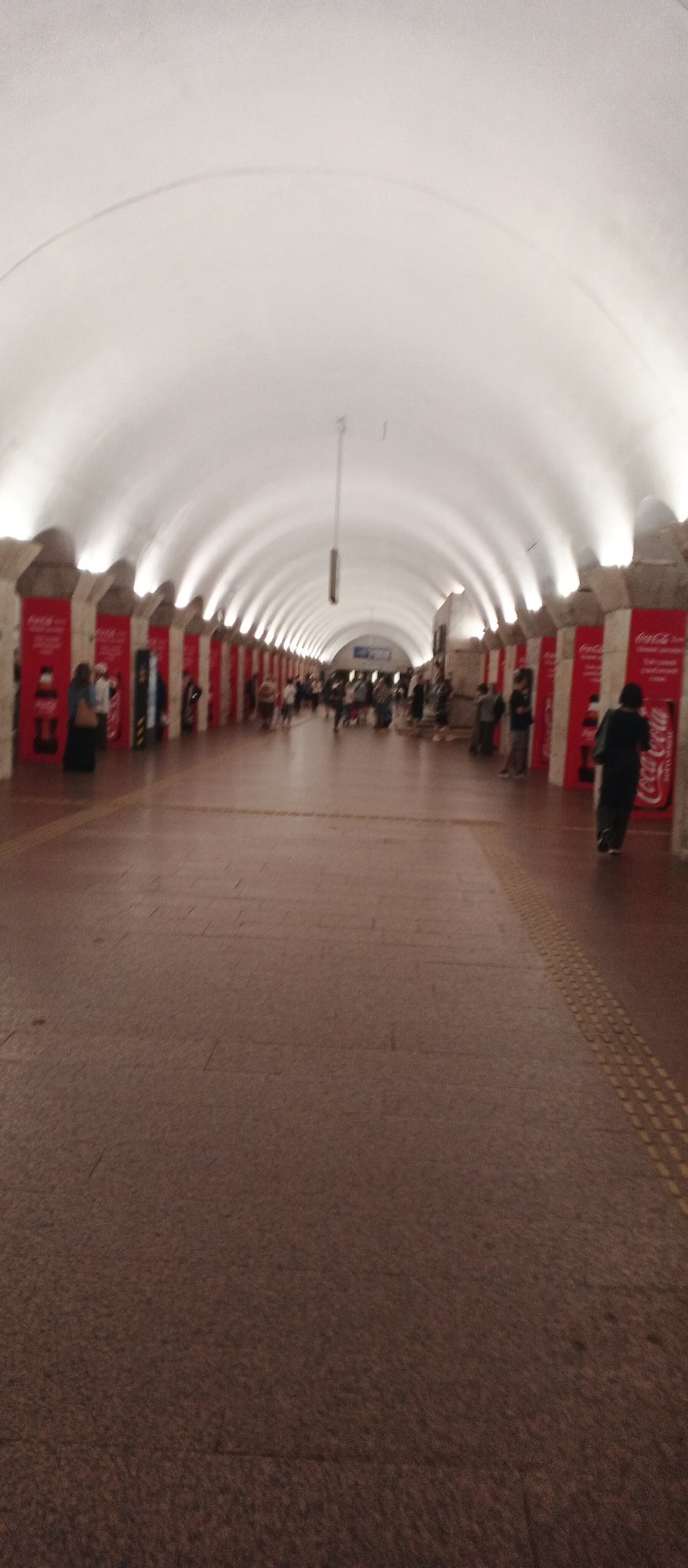 Inside a grand Ukrainian metro station with ornate Soviet-era design