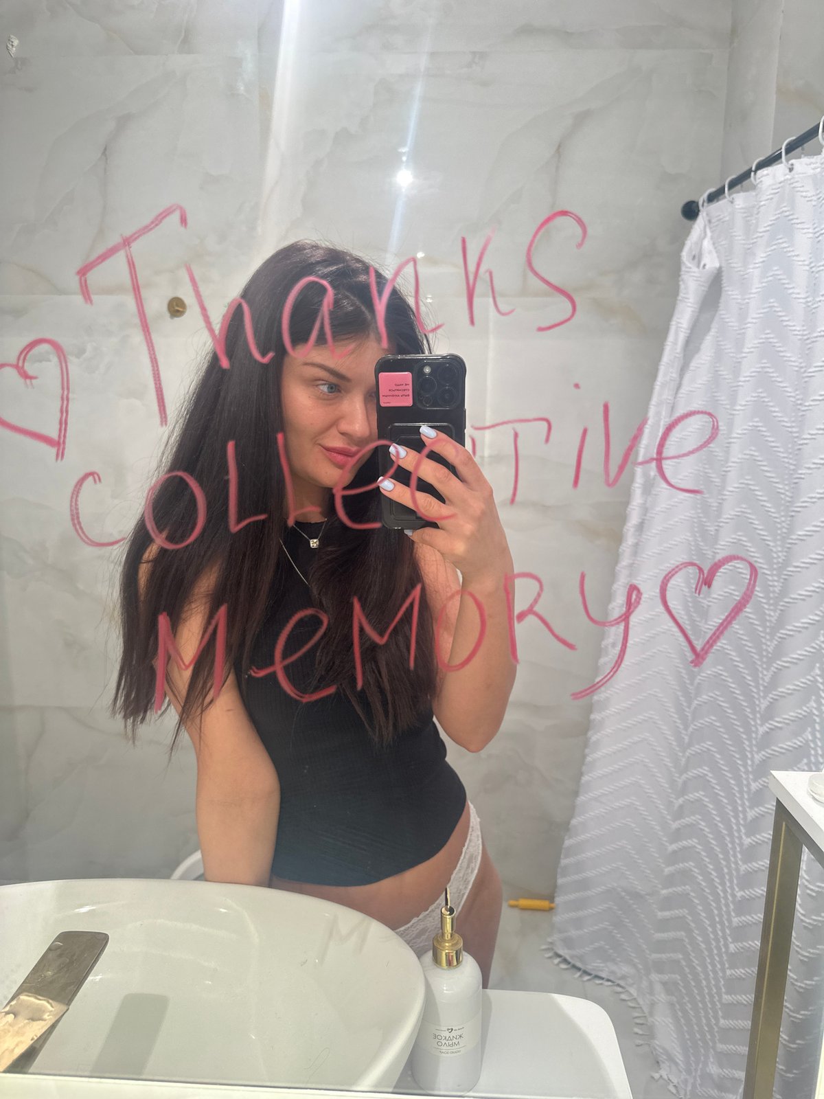 Woman takes bathroom mirror selfie in Khimki, Russia