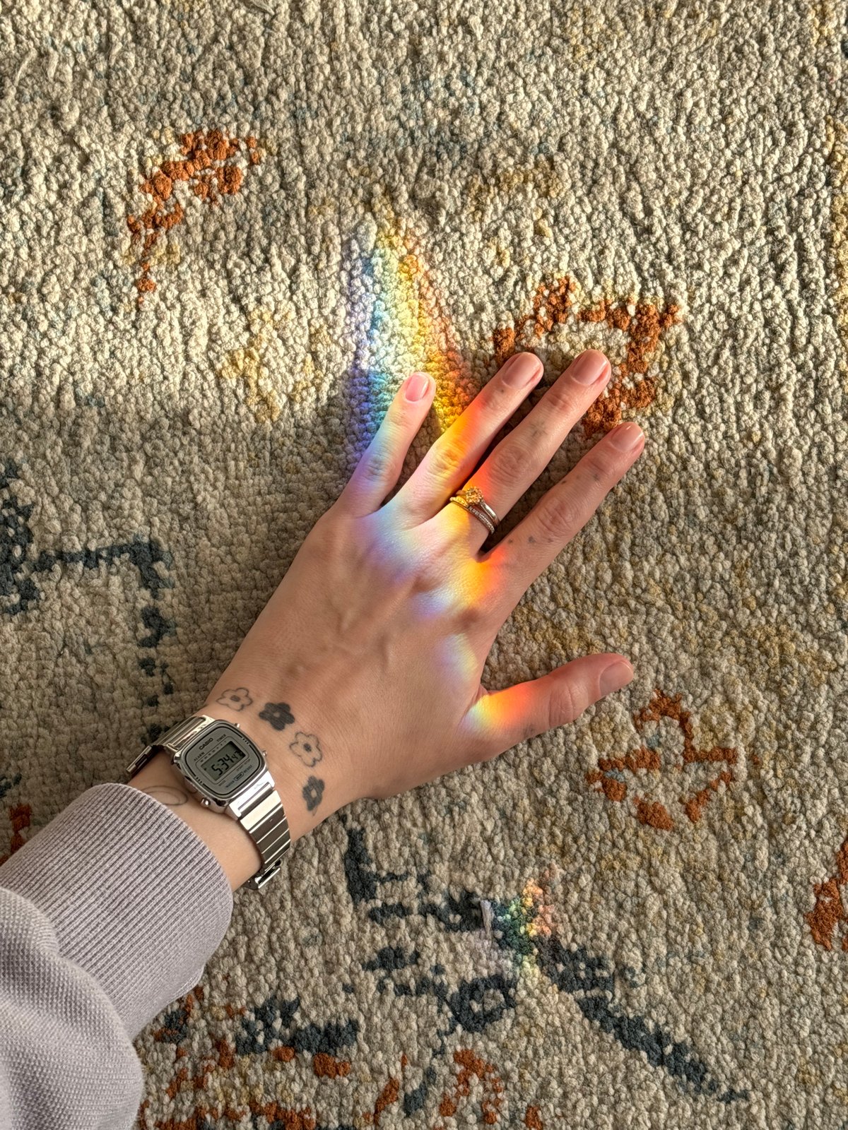 Rainbow light prism cast across hand in Bat Yam home