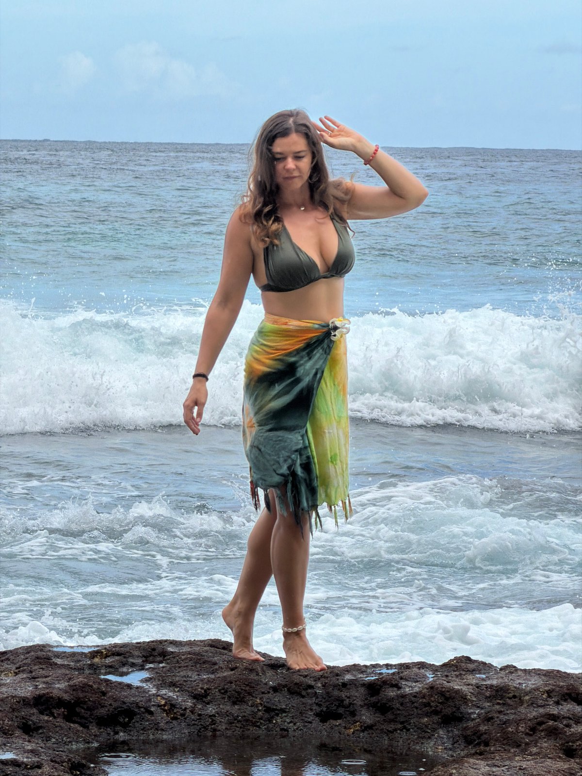 Woman poses at scenic Nusa Penida coastal locations