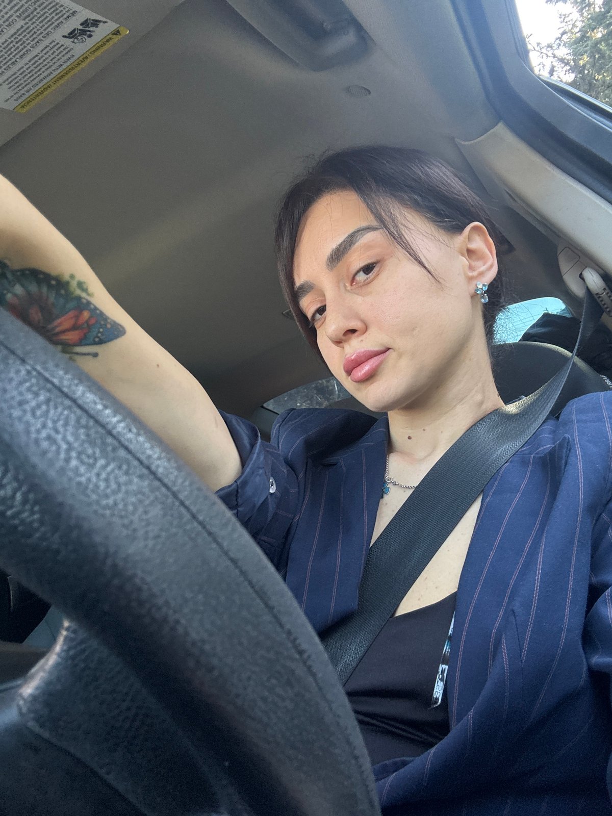 Woman makes playful face while driving in Tbilisi