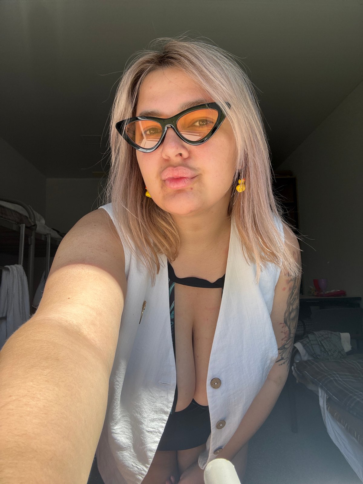 Woman takes playful selfies in orange sunglasses in Birobidzhan