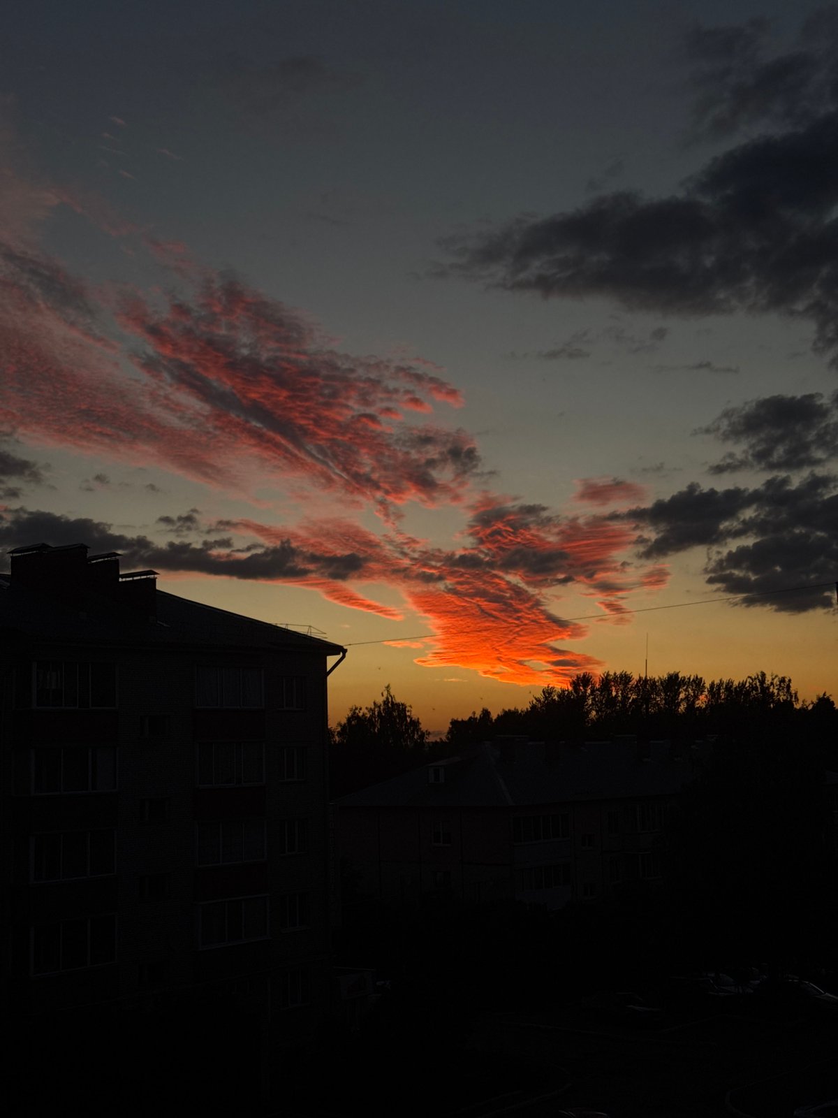 Fiery summer sunset lights up the sky over Zav'yalovo