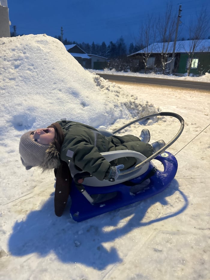 Child sleds on snowy street in Красный Маяк