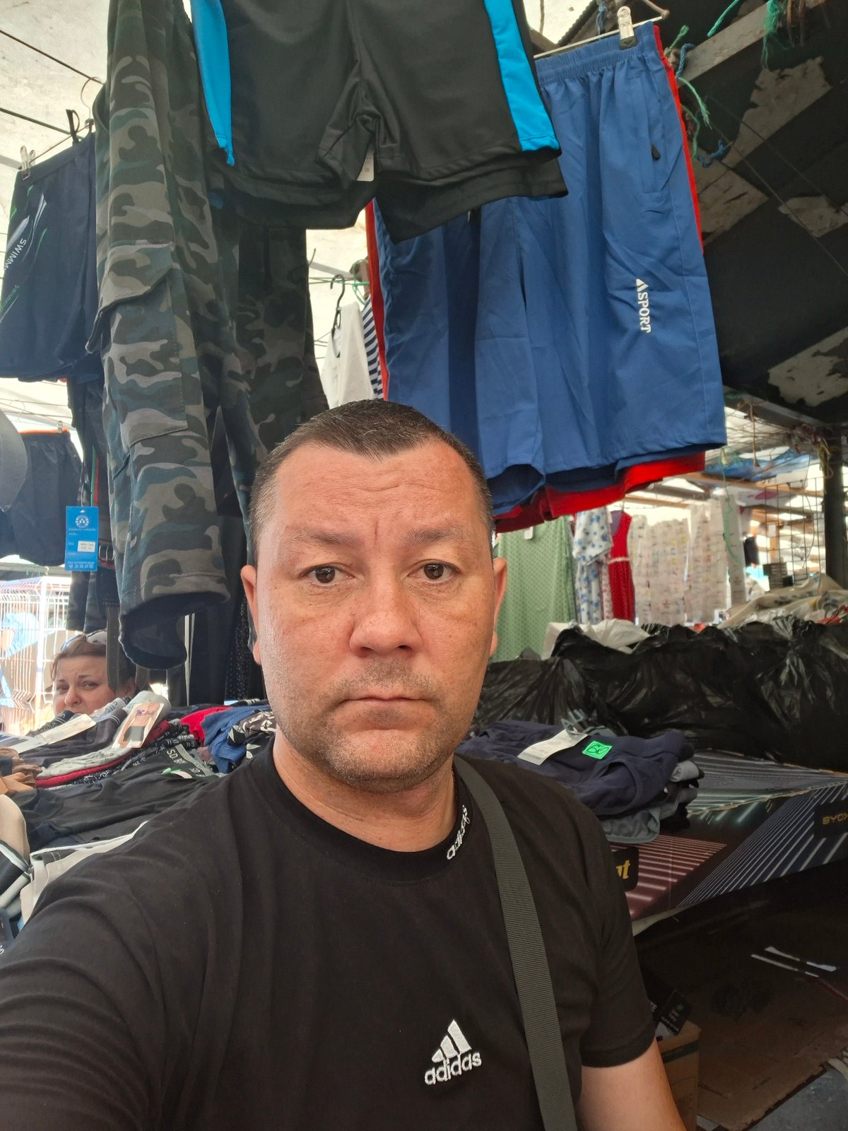Browsing clothing and cosmetics at an outdoor market stall