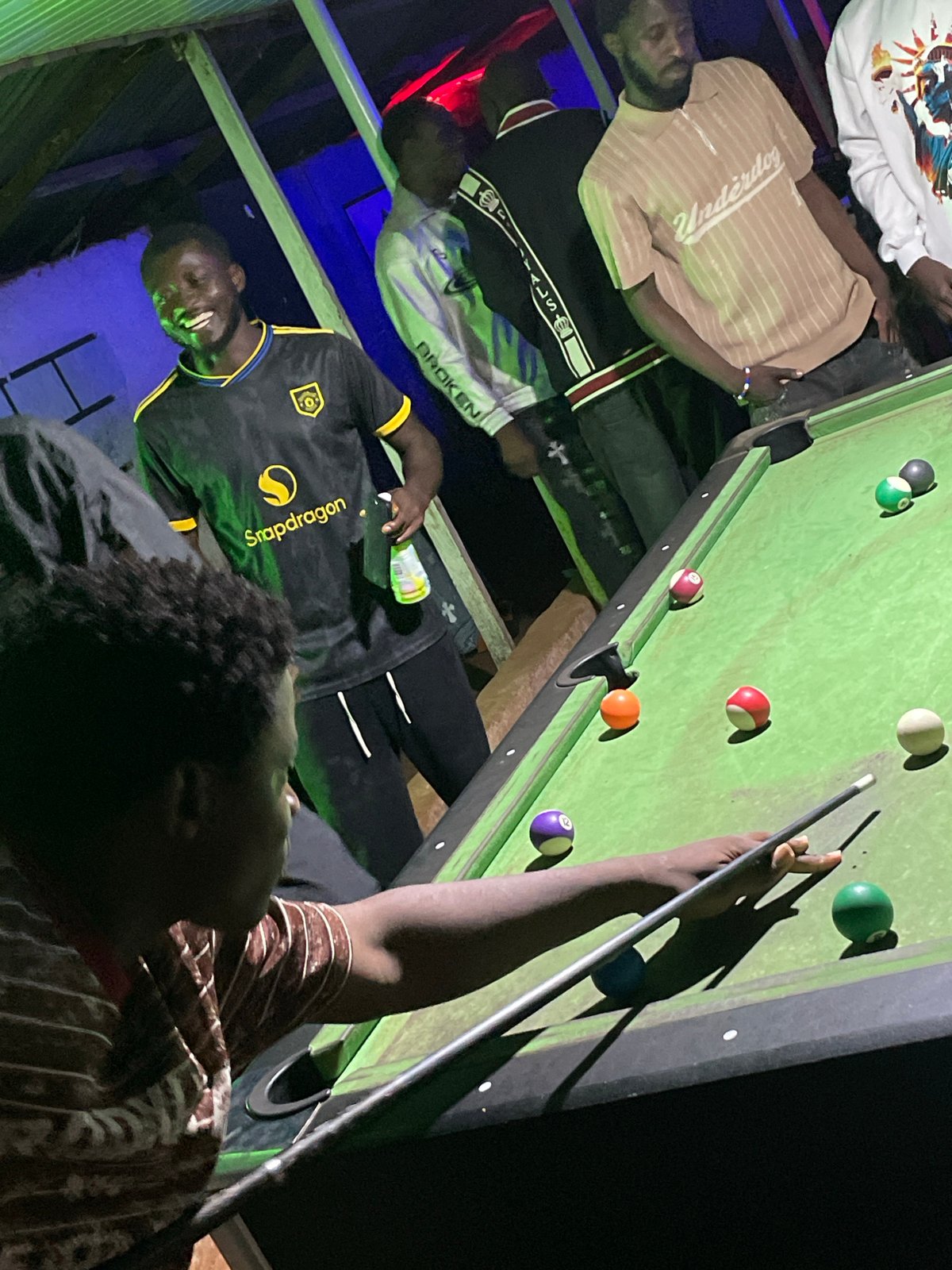 Late-night pool hall scene in Wumat, Nigeria