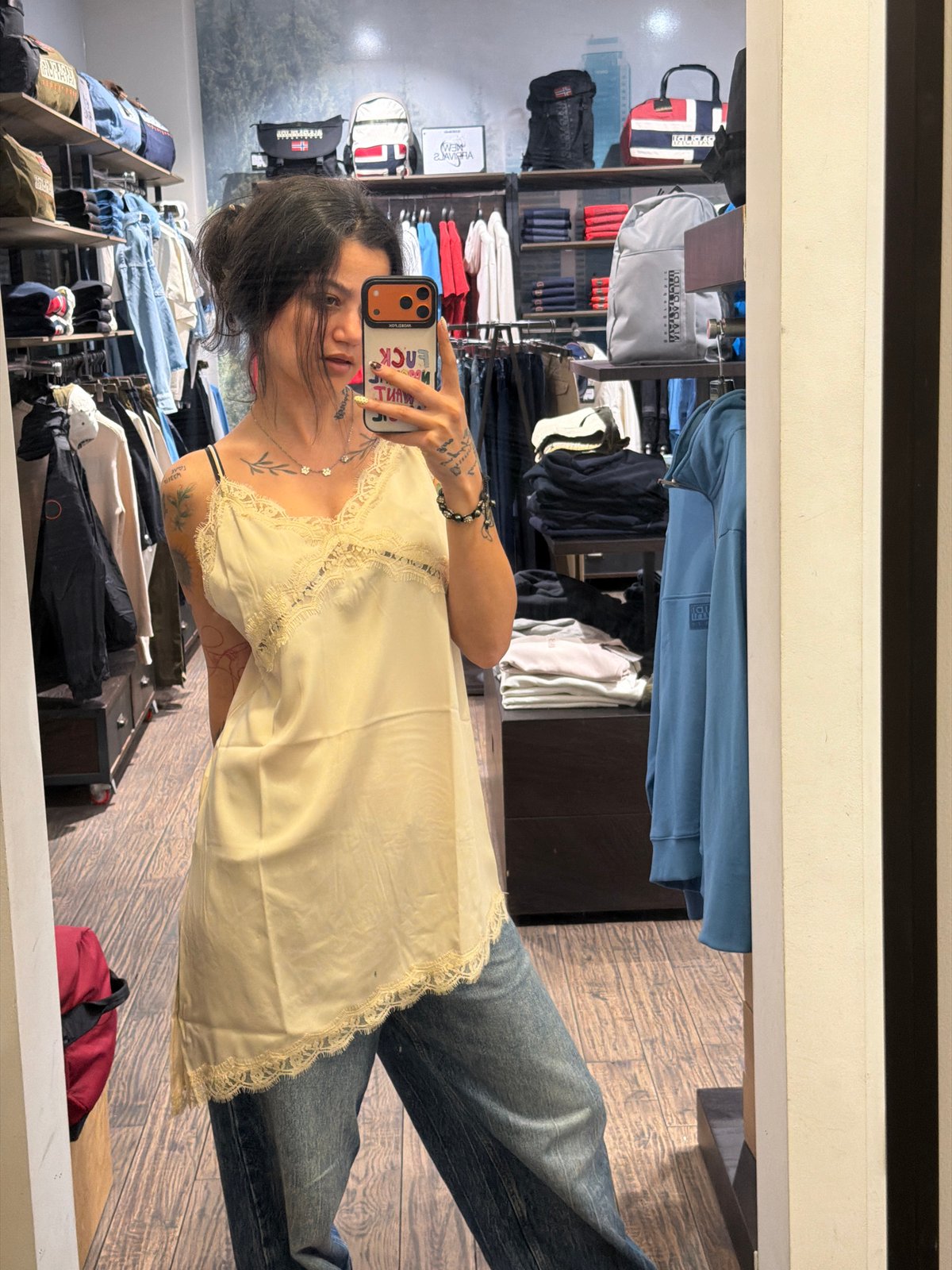 Woman takes mirror selfies while shopping in Sofia store