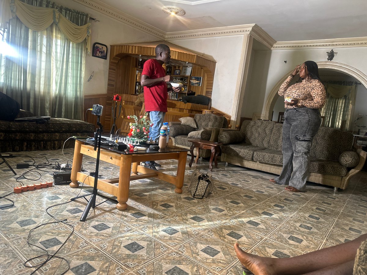 Casual indoor gathering captured during apparent filming in Jos
