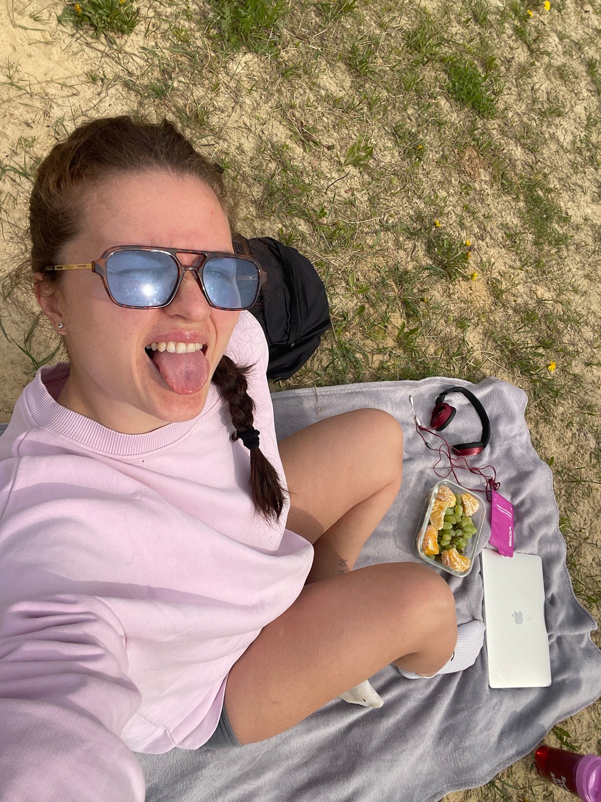 Woman enjoys lakeside picnic with technology in rural Russia
