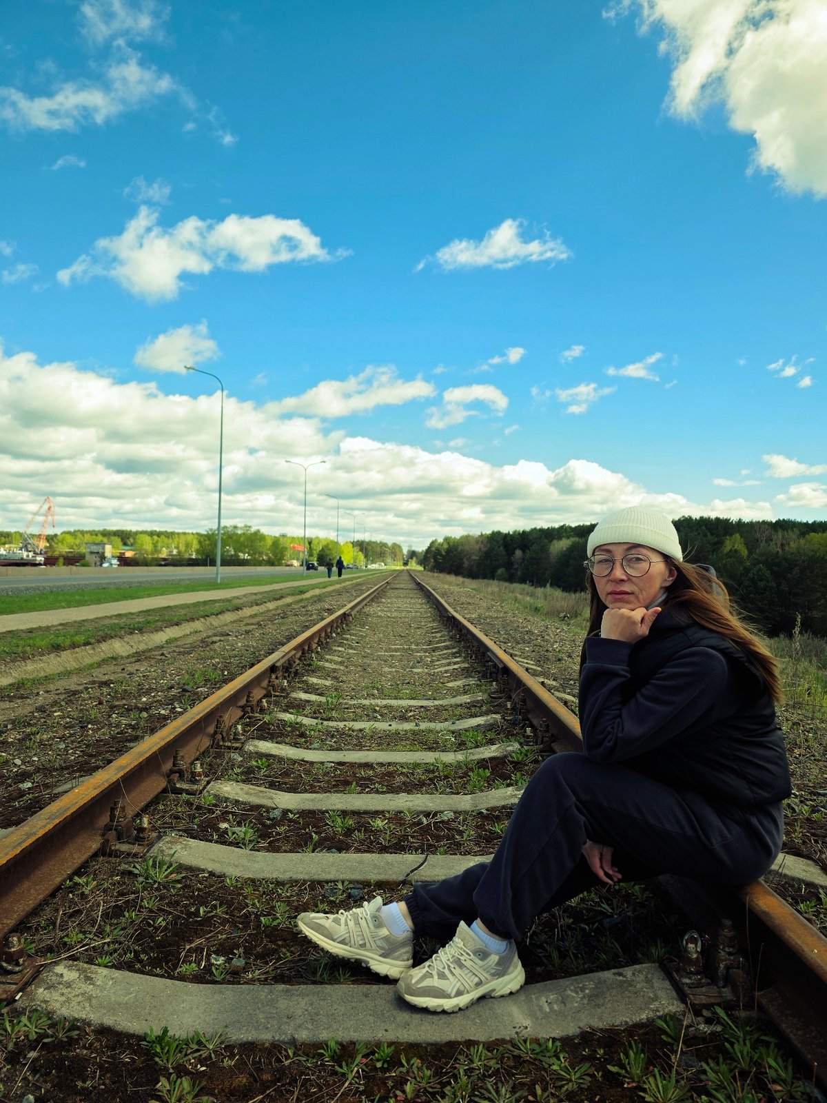 Woman poses on railway tracks in Chaikovsky, Russia