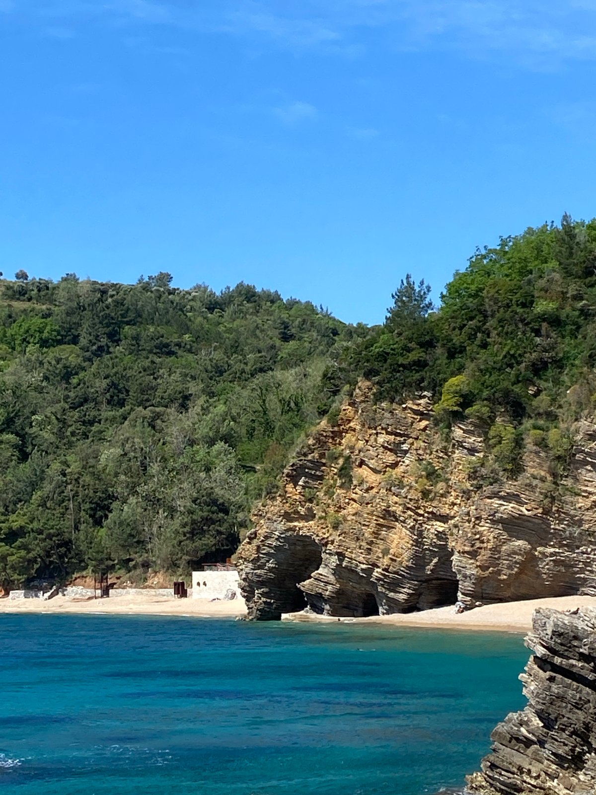Woman photographed resting in coastal rock formation, Budva Montenegro