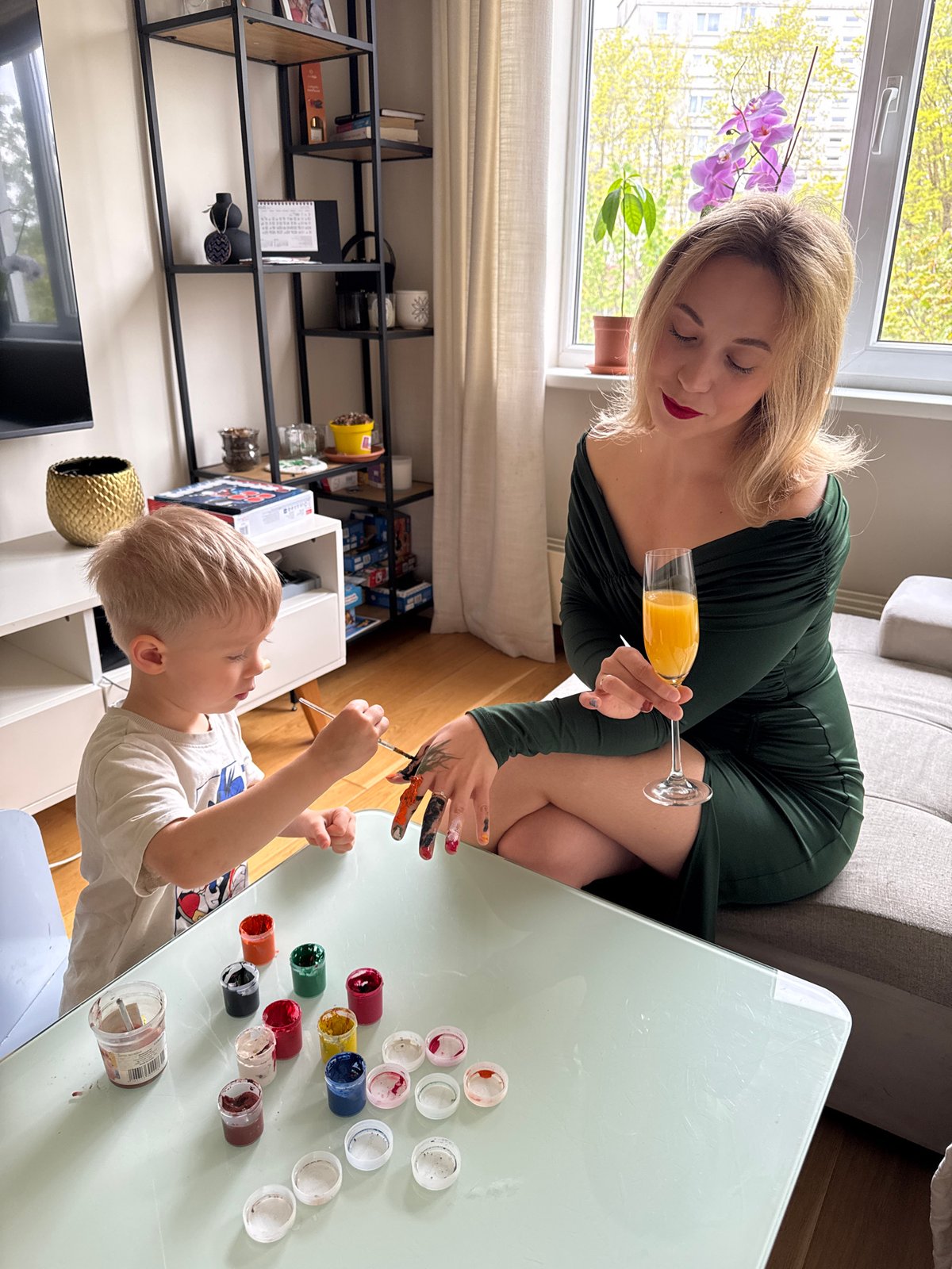 Mother and child share painting and manicure time in Riga apartment