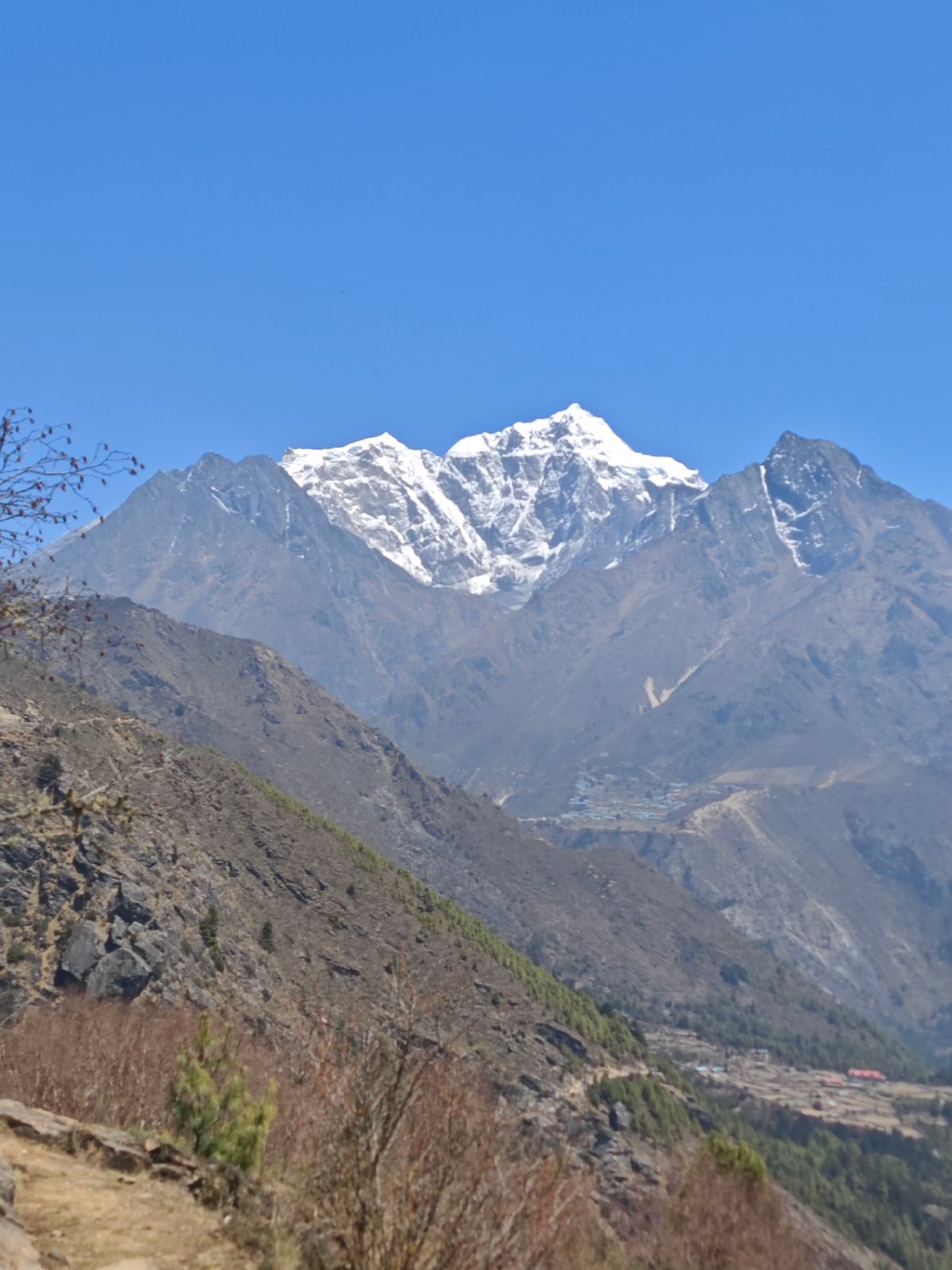 Hiker documents mountain views in Khumjung valley, Nepal