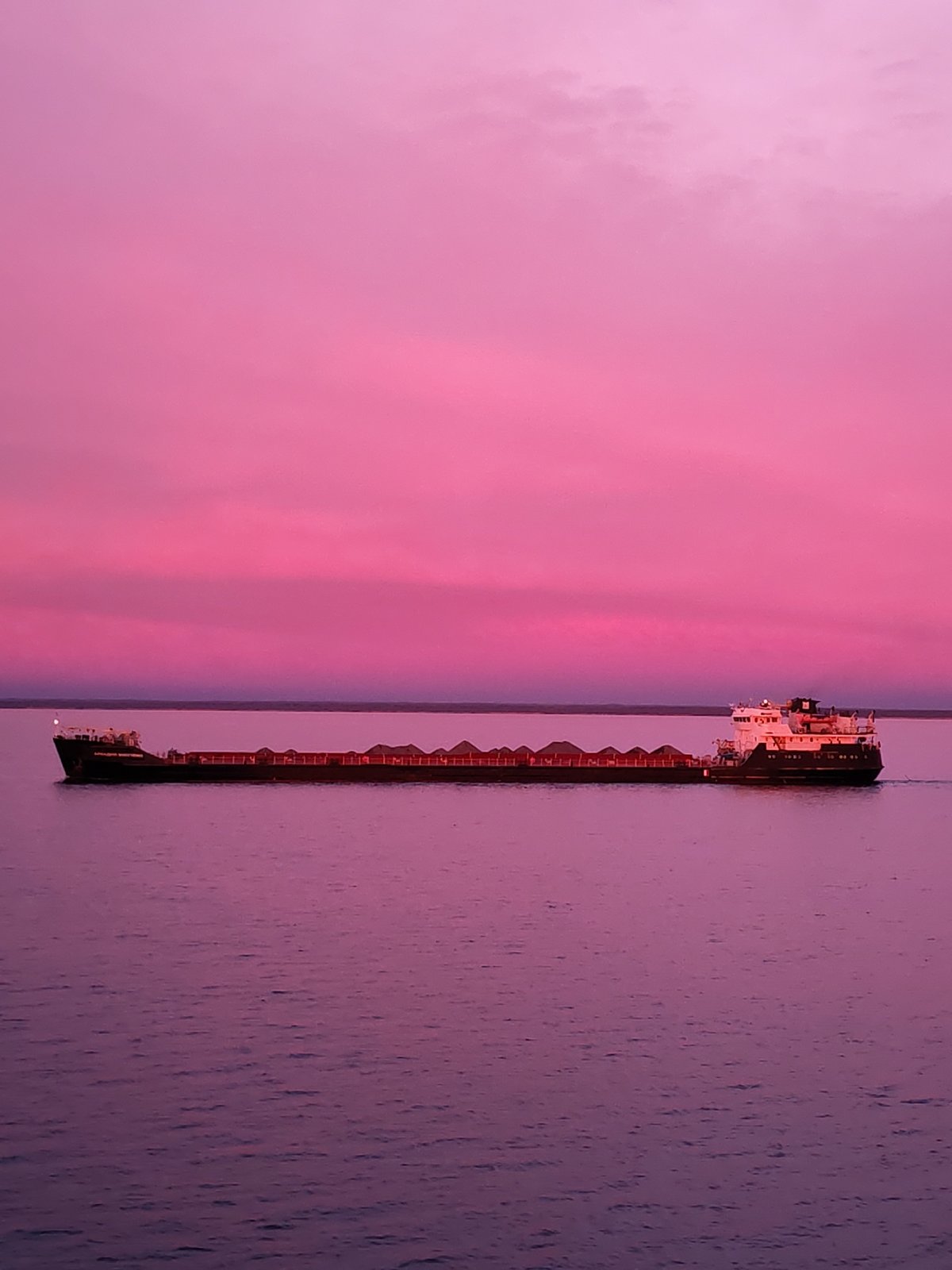 Freighter vessel spotted during pink dawn in Russian waters