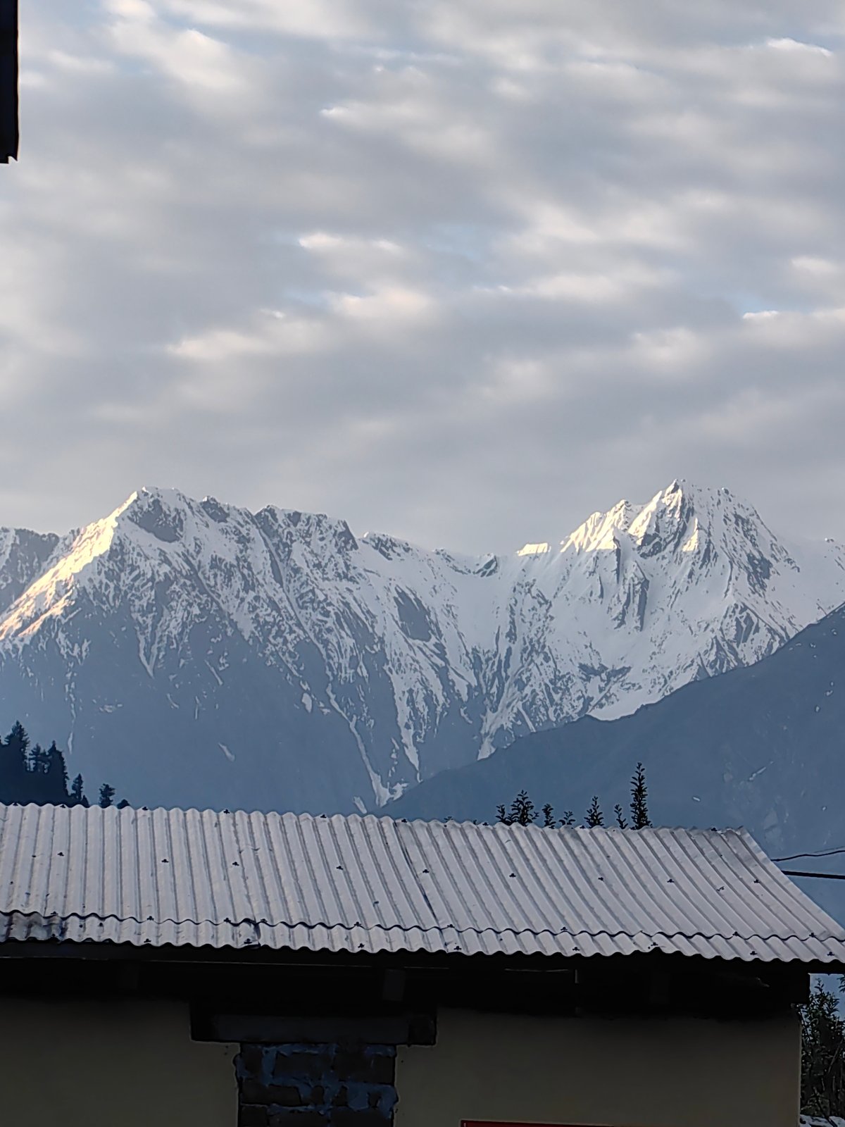 Himalayan village at the foot of snowy peaks