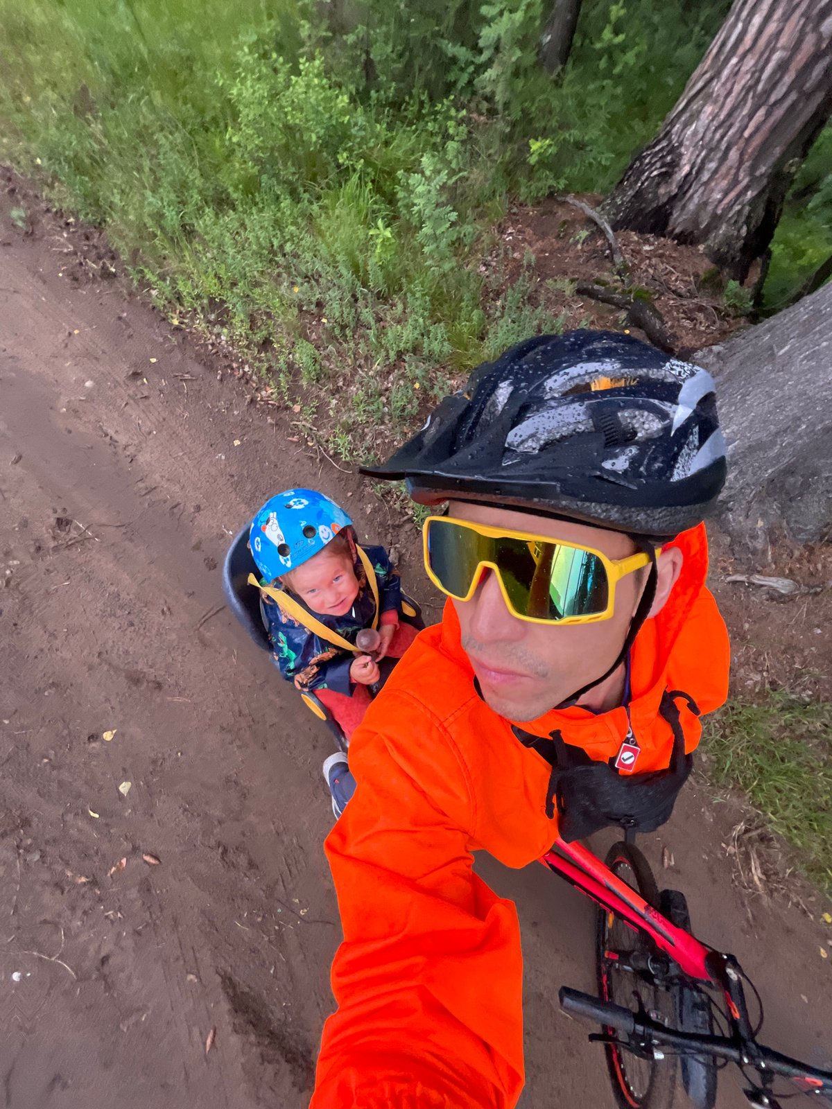 Mountain bike group rides muddy rural trails near Chaikovsky