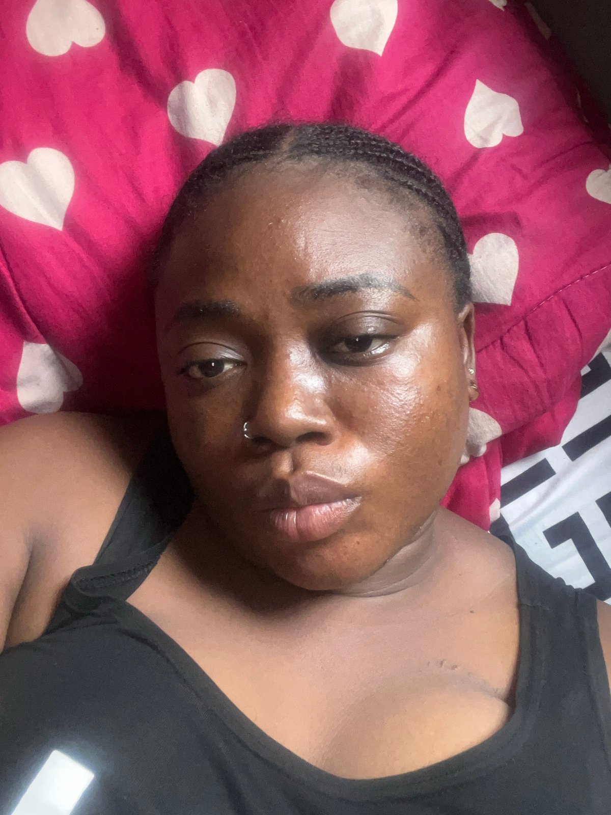 Woman photographs herself in bedroom with stuffed animal, Abuja