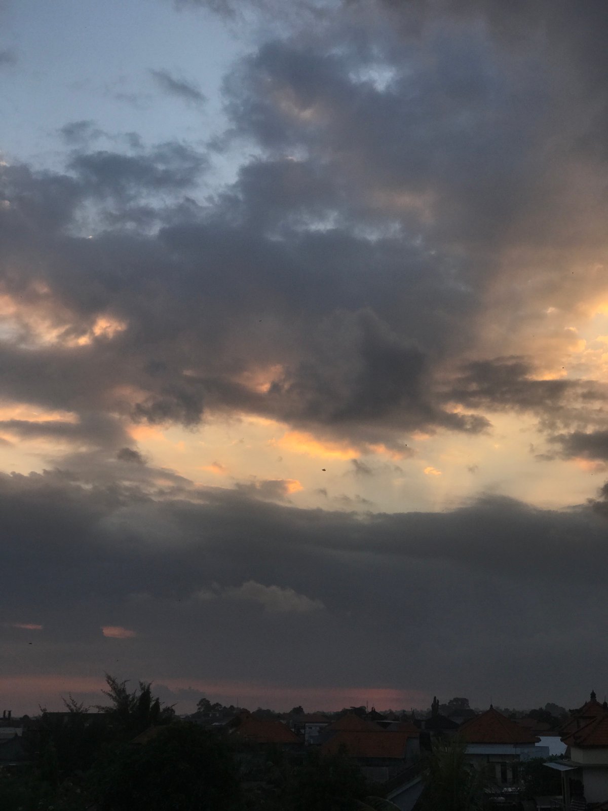 Dramatic sunrise clouds blanket North Kuta, Indonesia