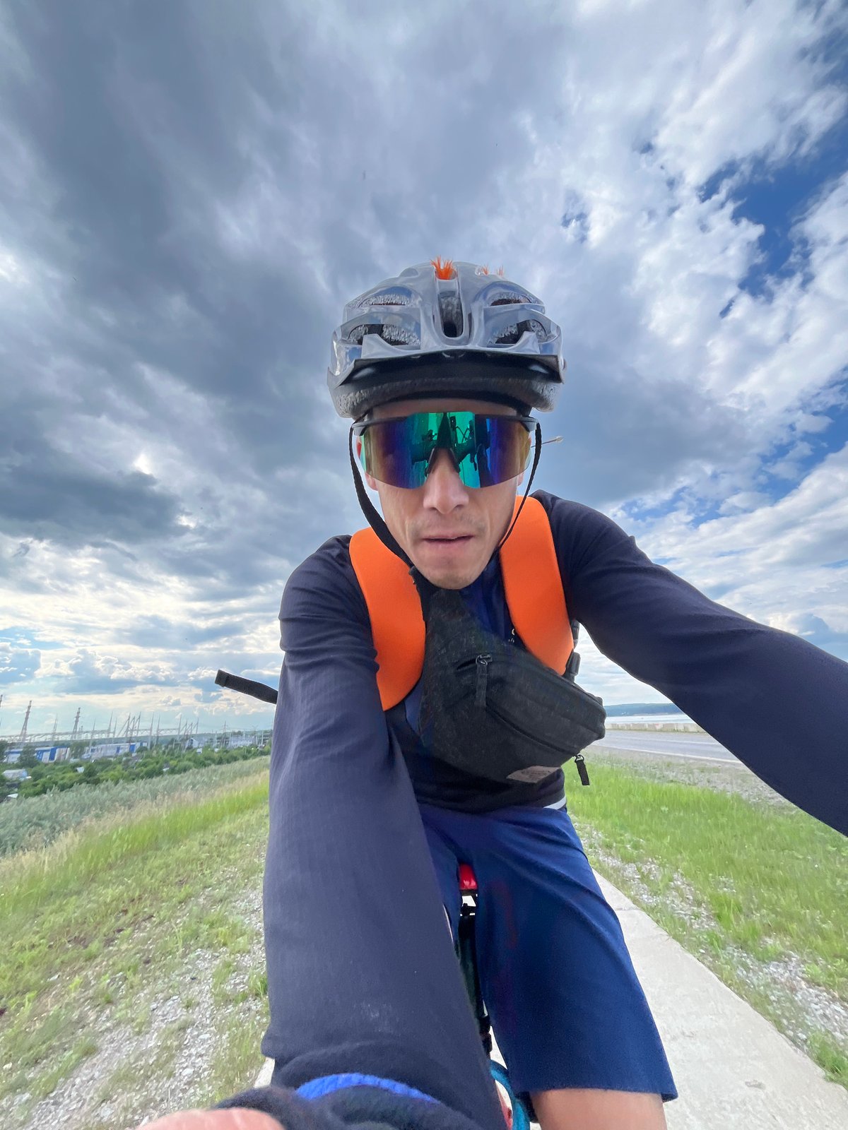 Cyclist in safety gear rides red bicycle in Chaikovsky