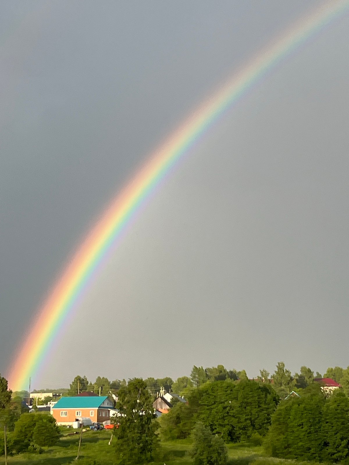 Double rainbow over a Russian village after a summer storm