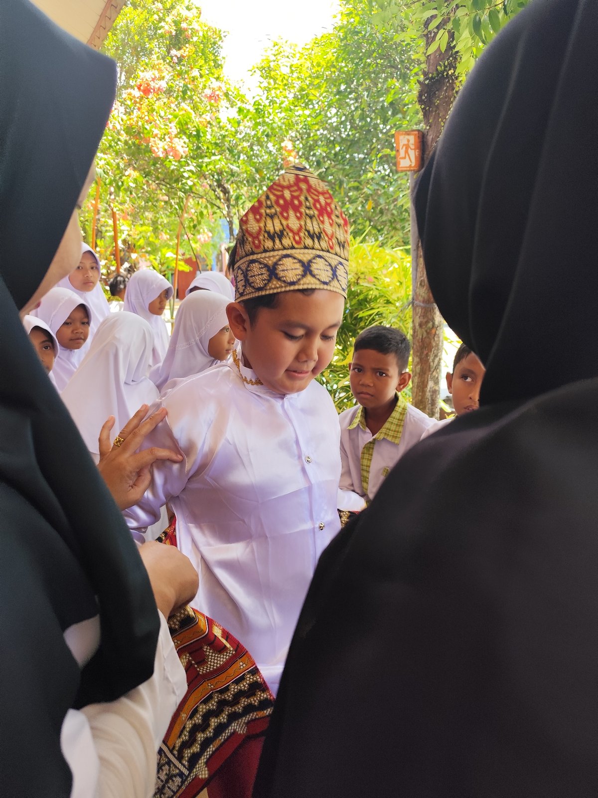 Children in traditional dress at a cultural school gathering