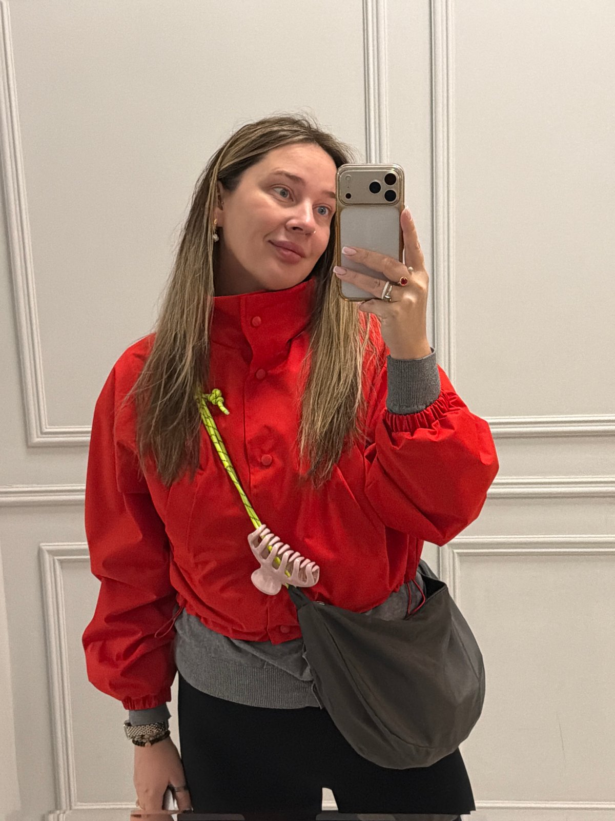 Woman takes morning selfies in red jacket, Moscow