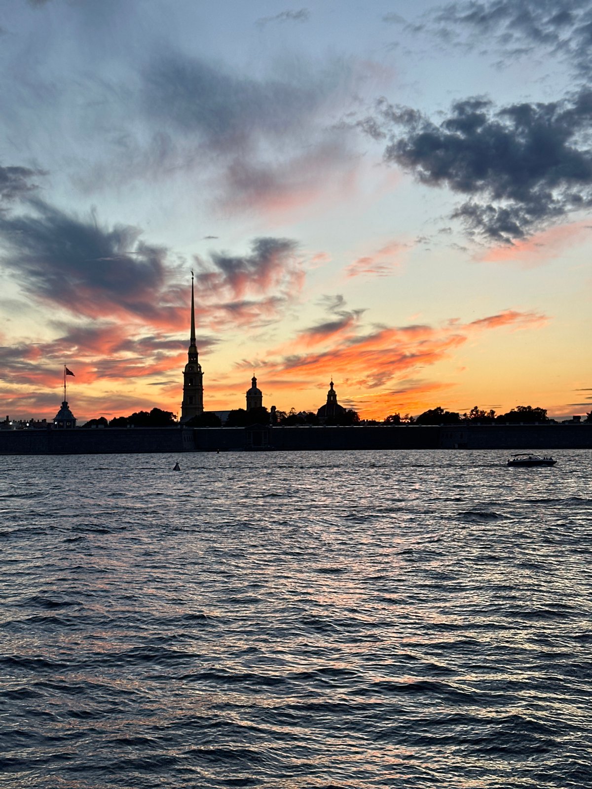 City skyline at golden hour, sky ablaze with color