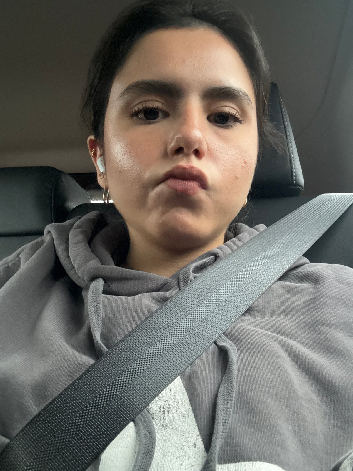 Woman takes selfie in car passenger seat in Austin