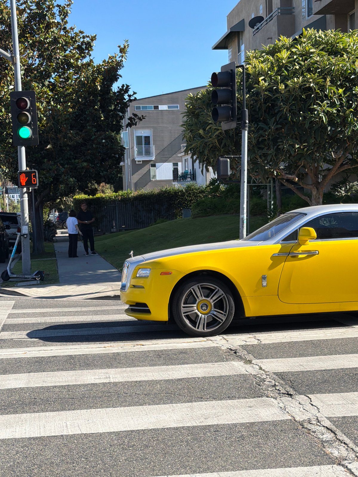 Yellow Rolls-Royce parked on a sunny LA street