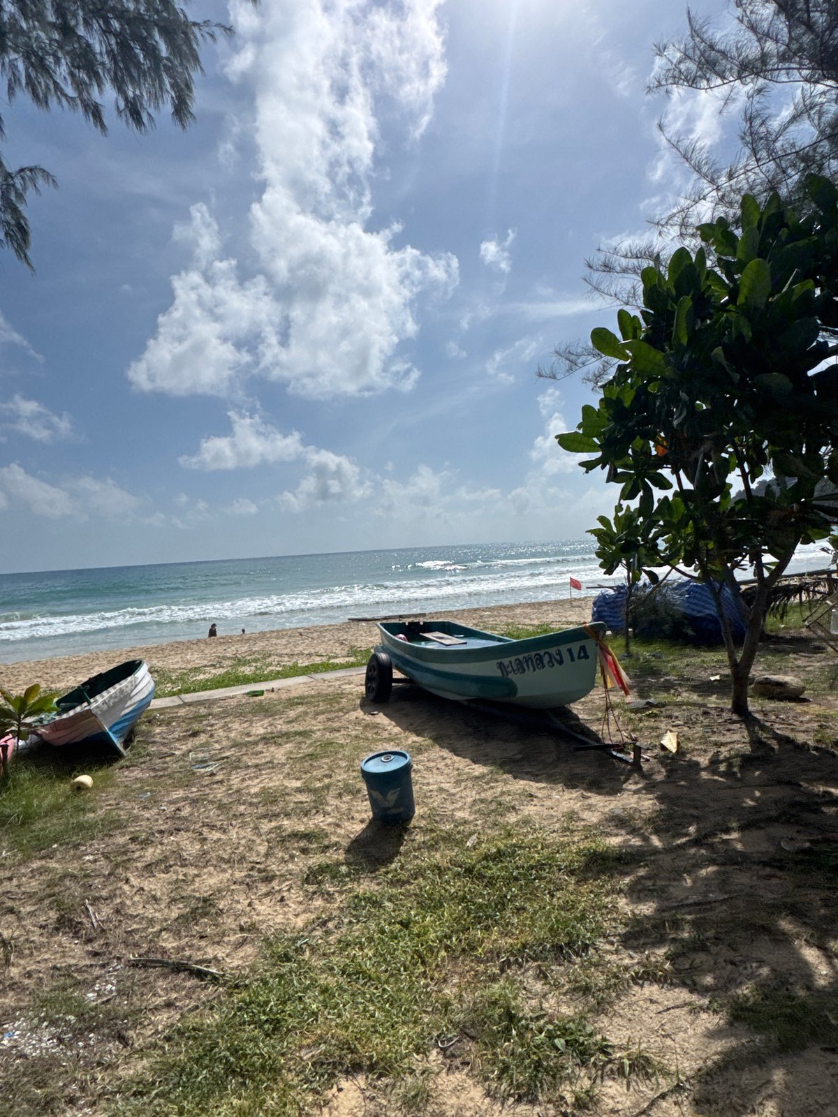 Karon Beach morning: parasailing, shoreline activity, and calm surf
