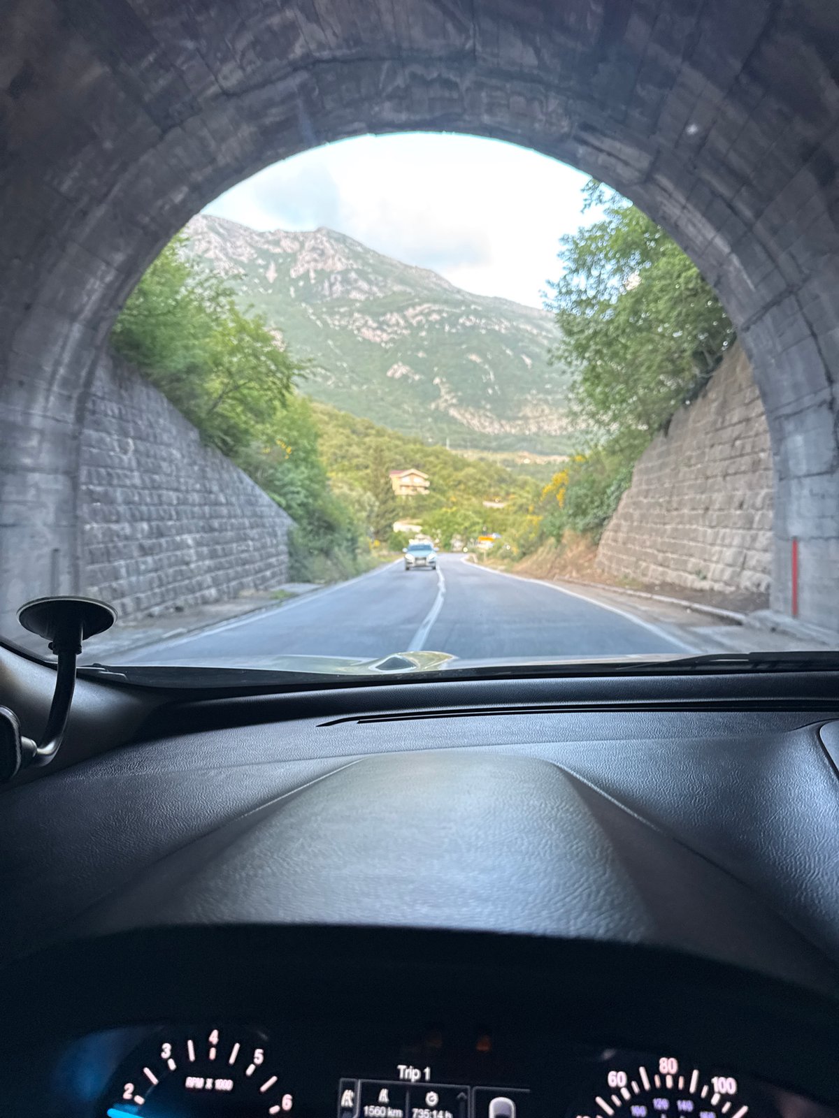 Driver travels through stone tunnel in Montenegro mountains