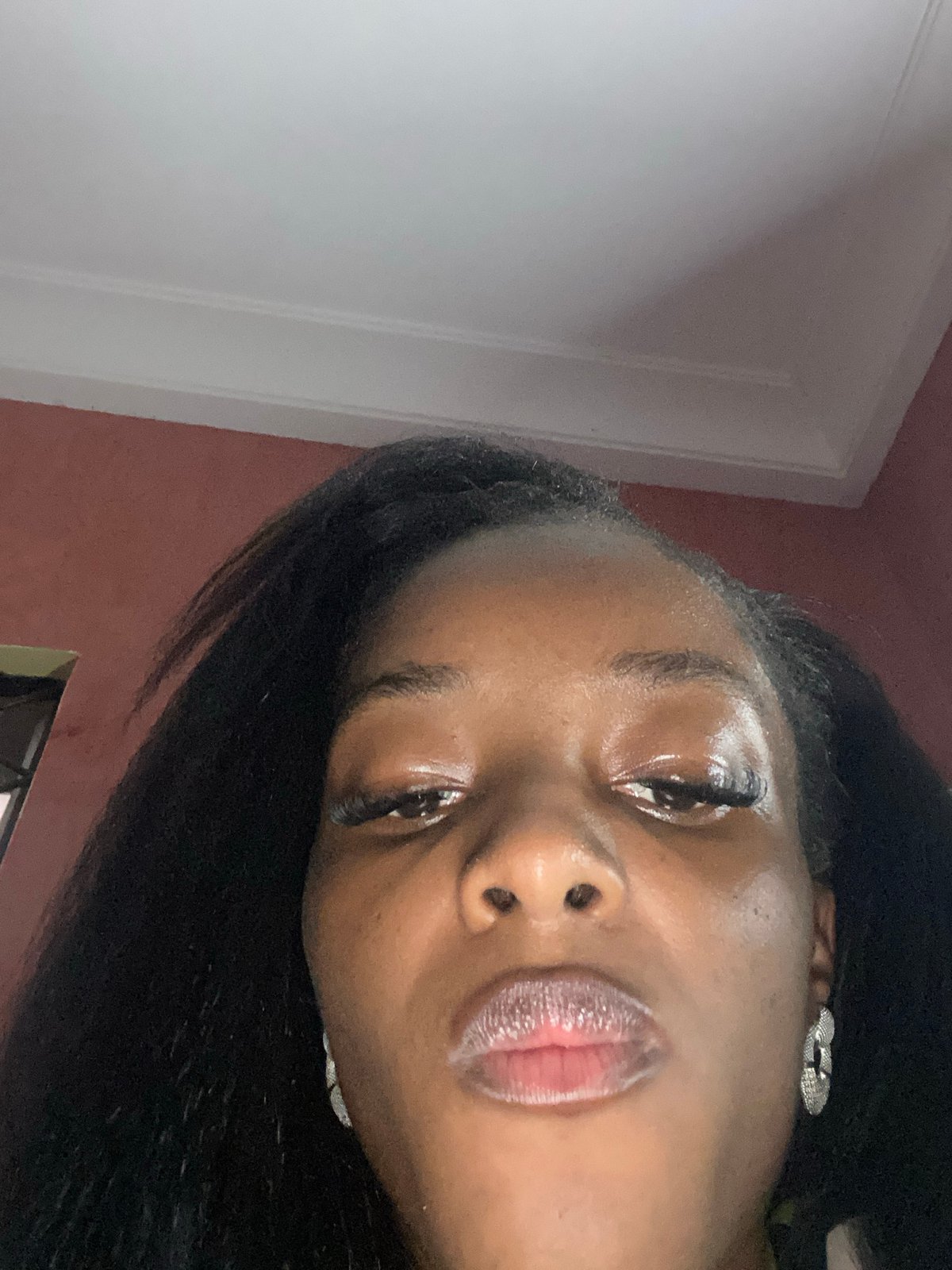 Woman photographs herself eating french fry indoors in Jos