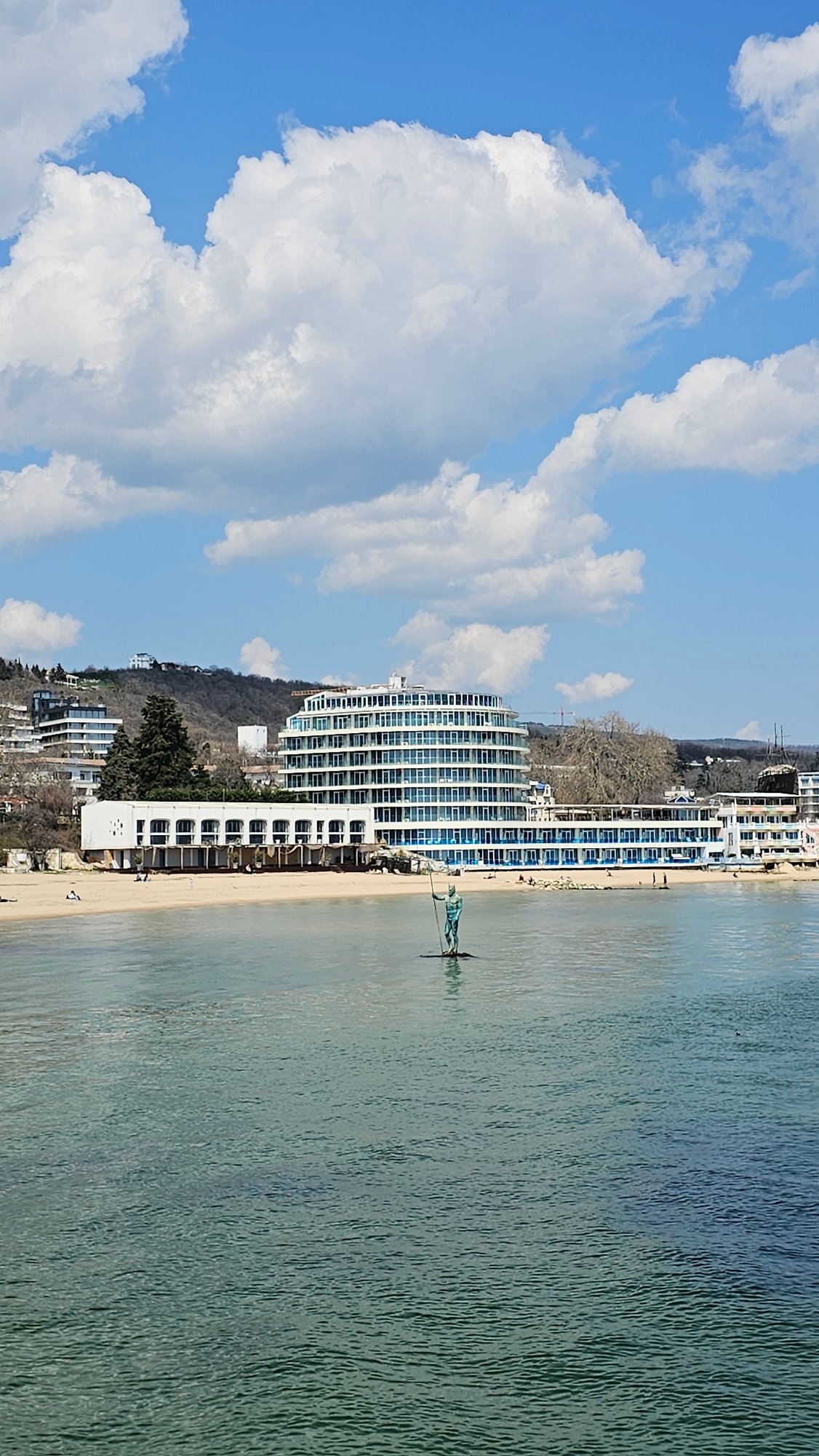 Tourist documents Varna coastline sculptures, dining, buildings during morning visit