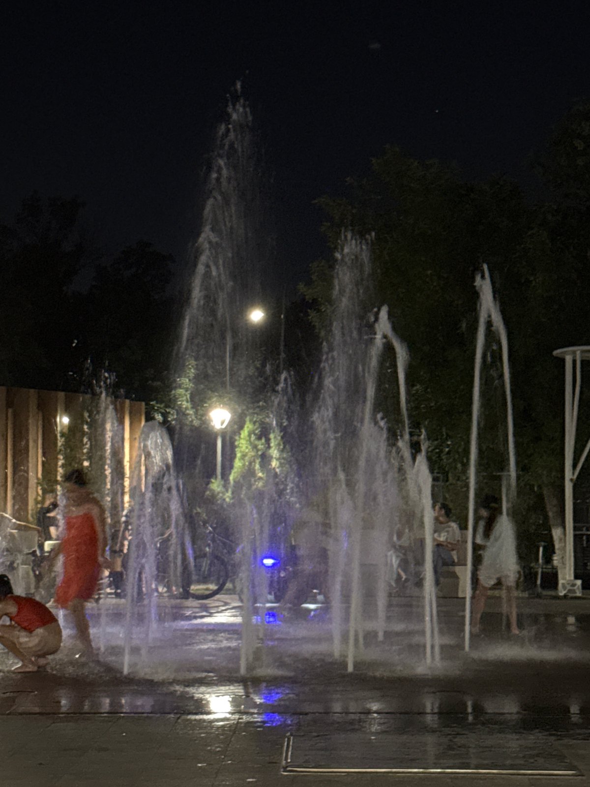 Shymkent park at night: splash pad fun and ride-on toy cars