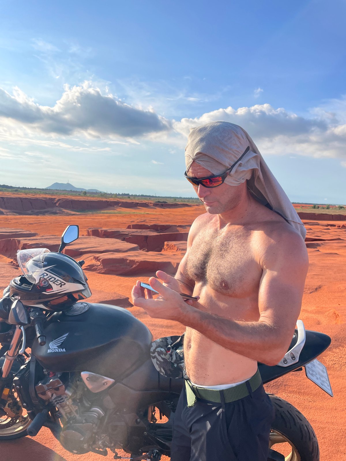Motorcyclist explores Mui Ne red sand dunes, Vietnam
