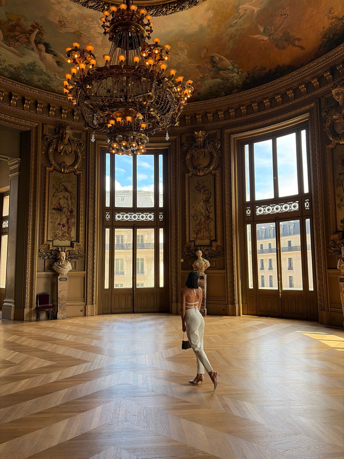 Visitors explore Palais Garnier opera house and Parisian rooftops