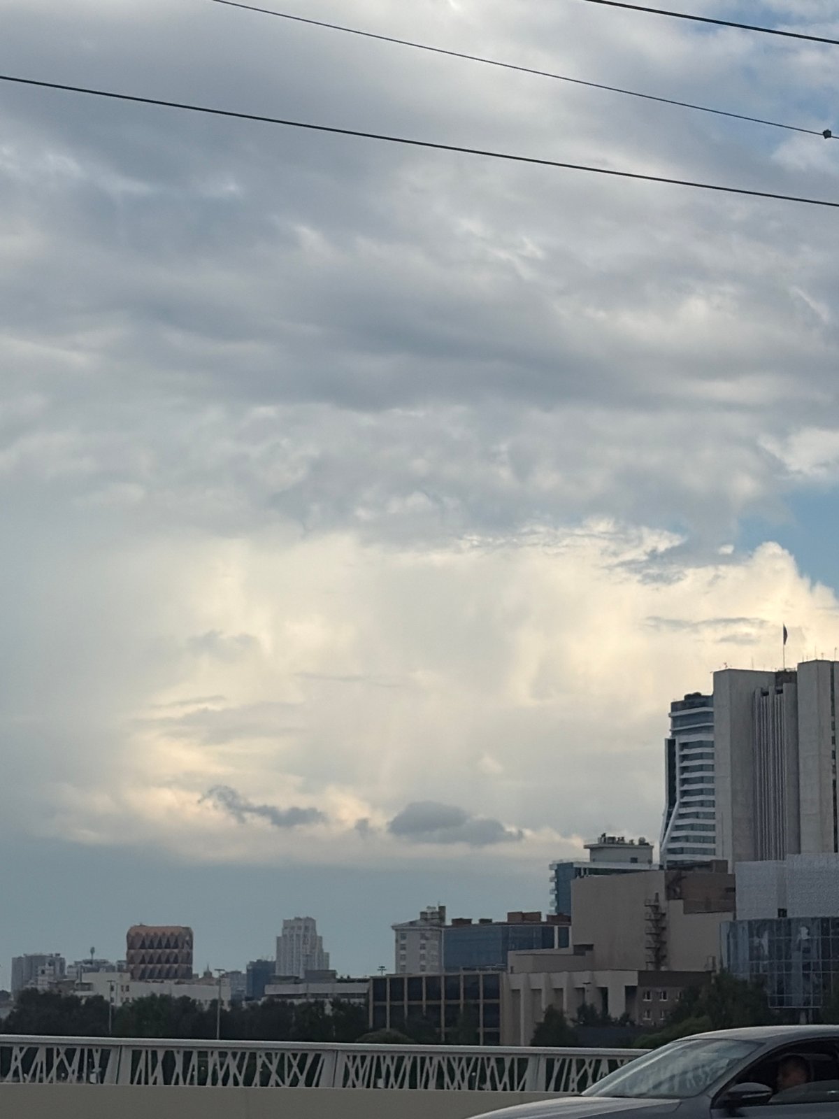 Yekaterinburg skyline under clouds, glass towers and street fence