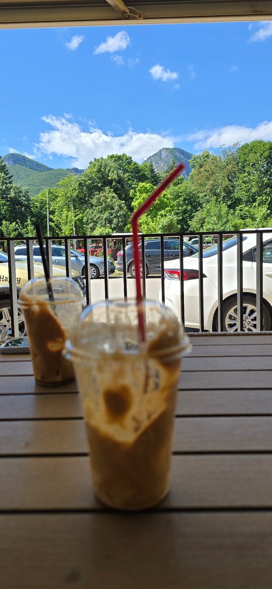 Coffee break at outdoor cafe with mountain street view