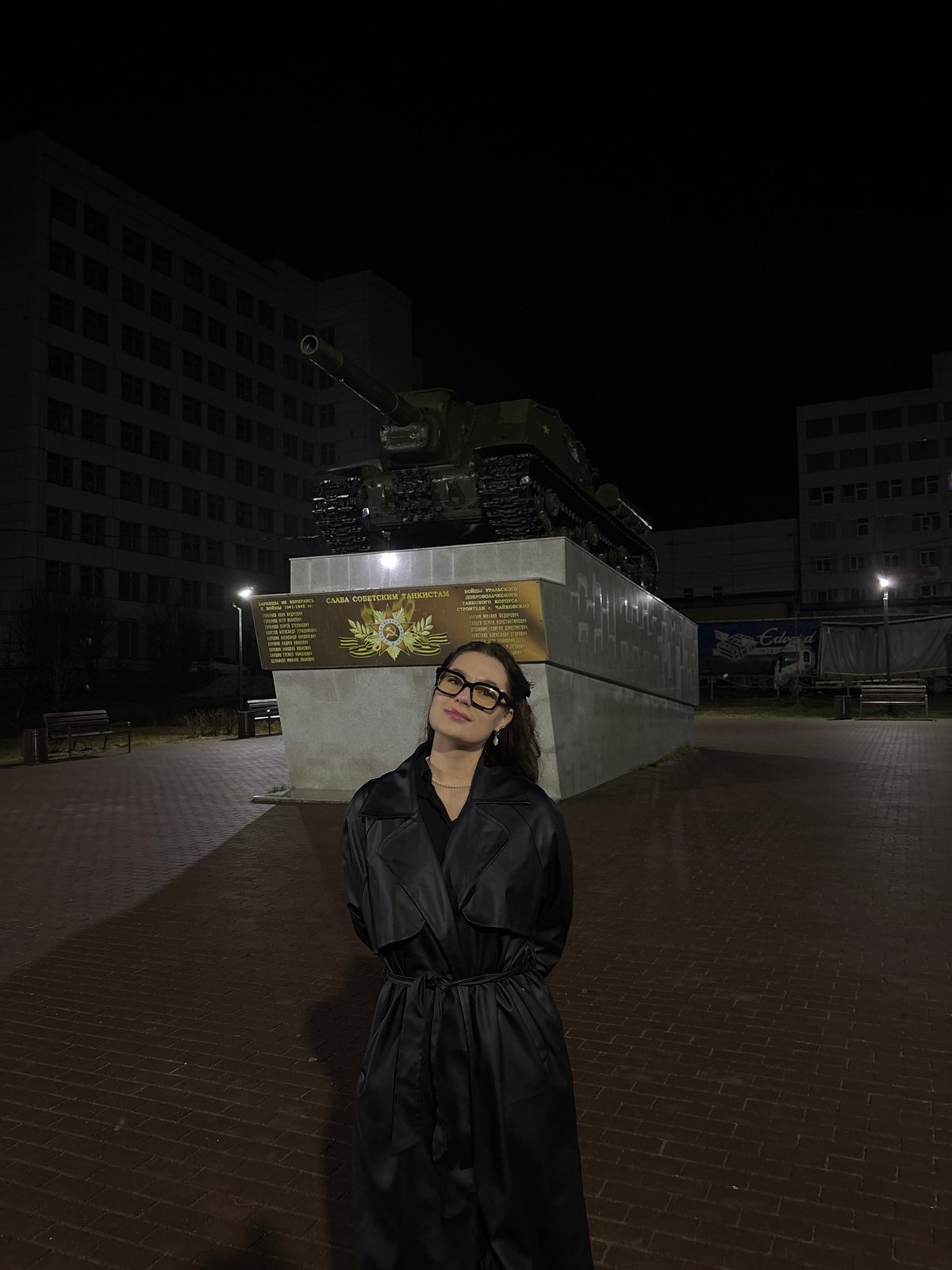 Woman poses at Soviet tank monument in Chaikovsky, Russia