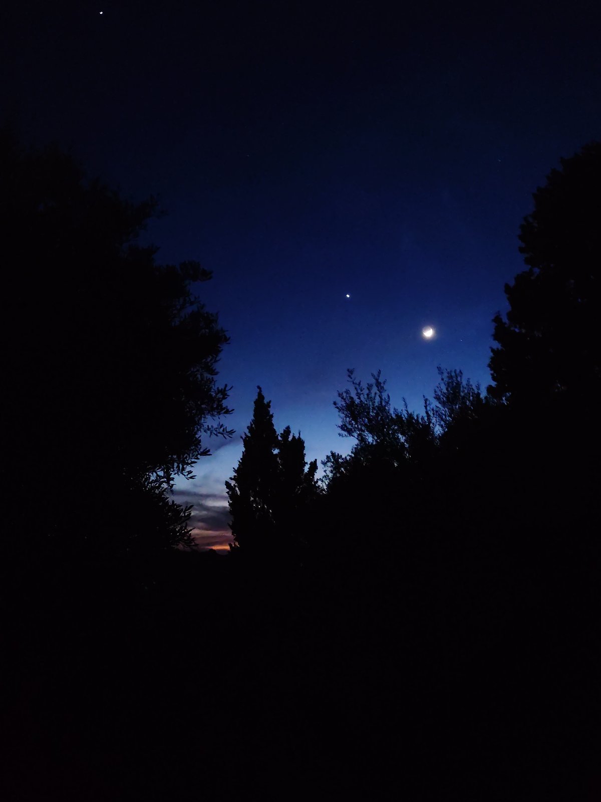 Crescent moon and bright planet observed in evening sky