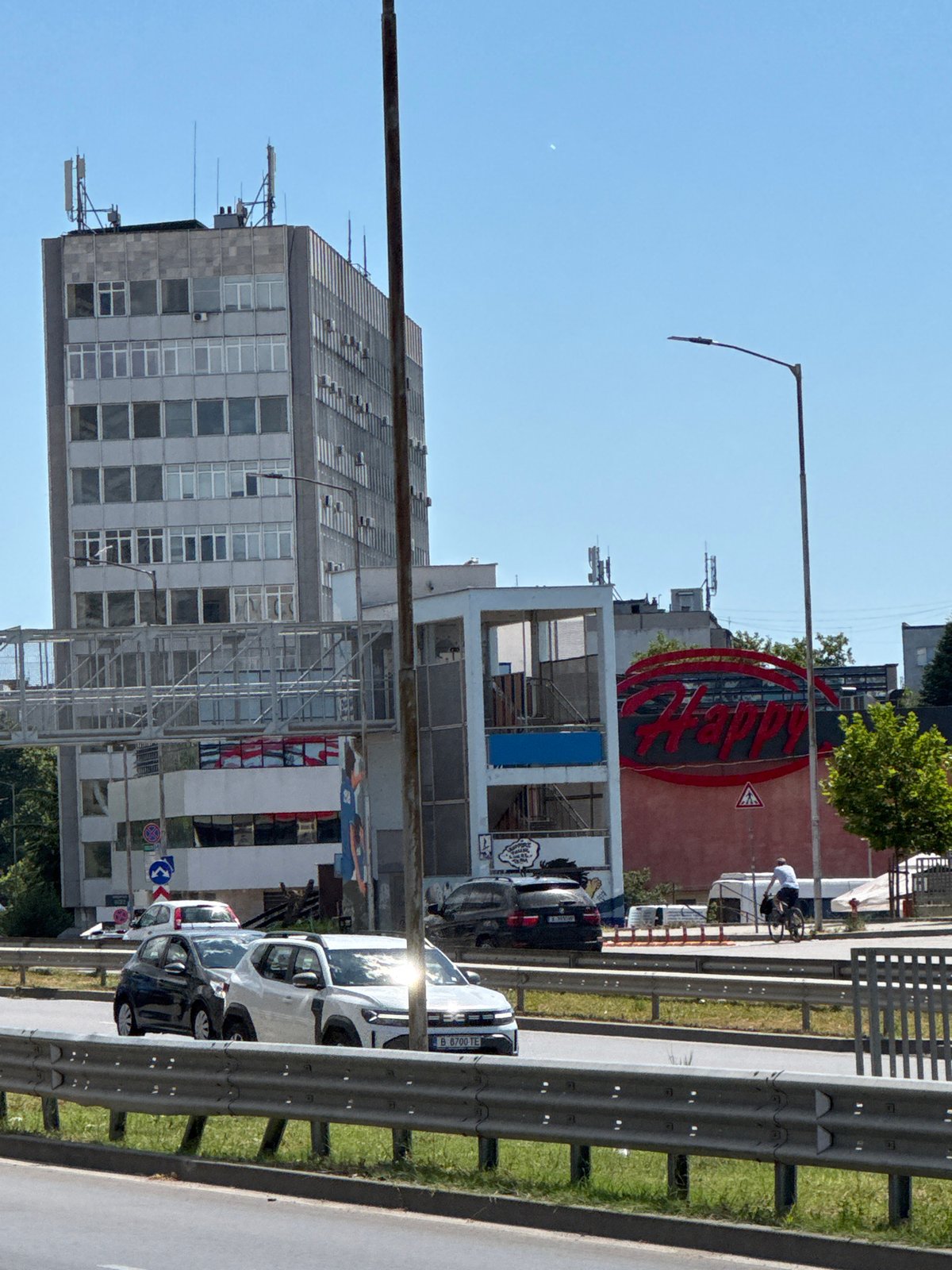 Varna street corner: café tables, traffic, and a bakery window