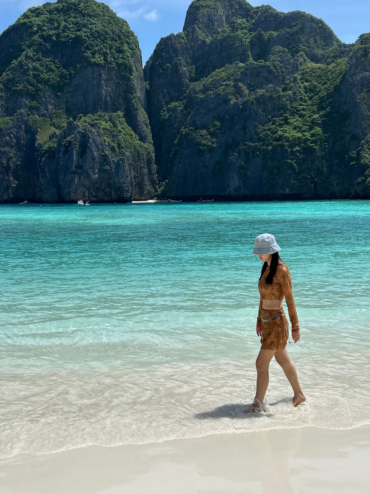 Strolling Ao Nang's turquoise shoreline in tropical summer heat