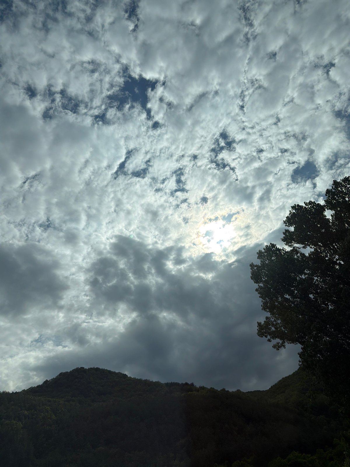 Sunlight breaks through clouds over Bulgarian mountain landscape