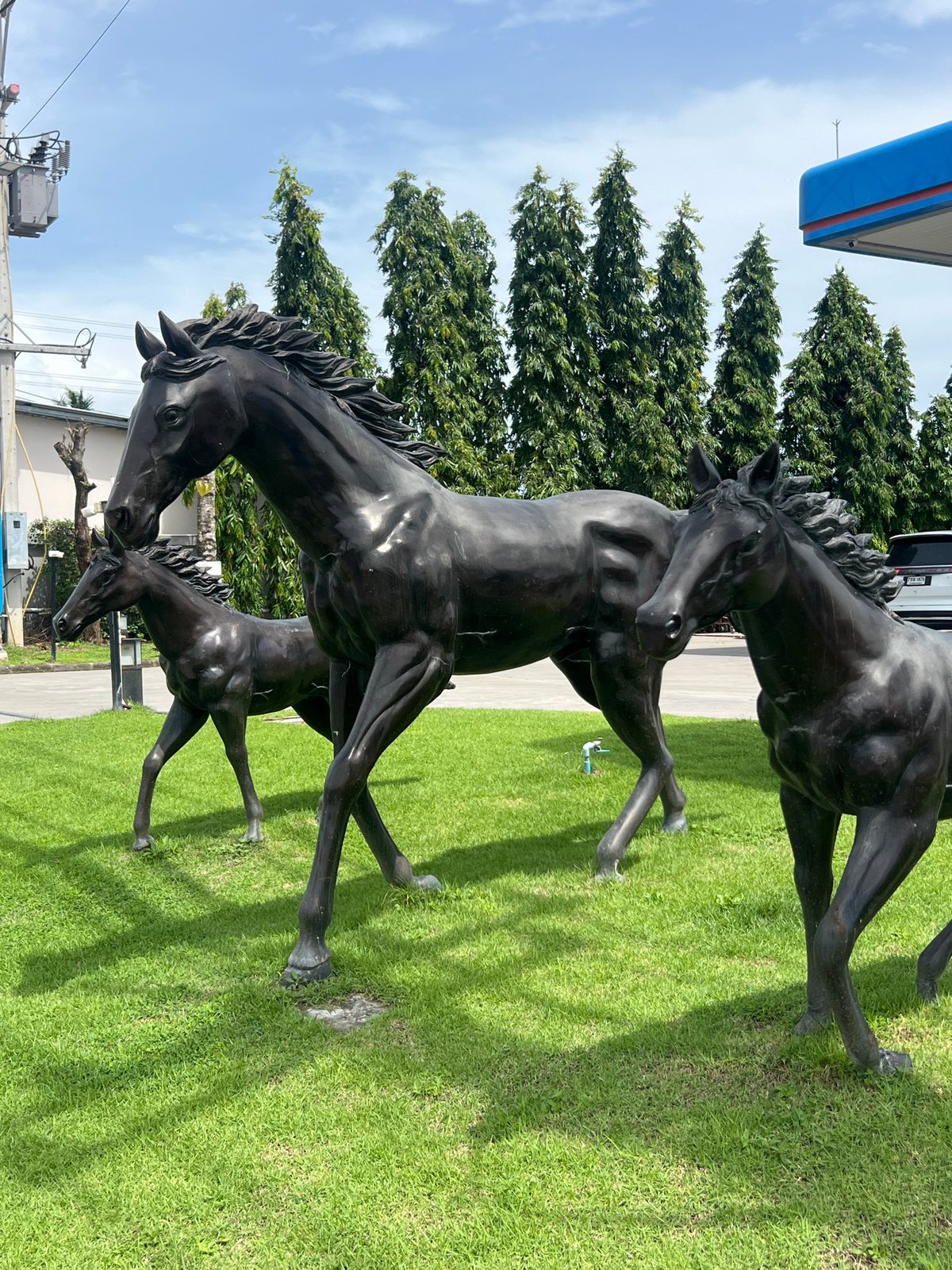 Roadside shrine in Pa Khlok with horse, elephant, and deity sculptures