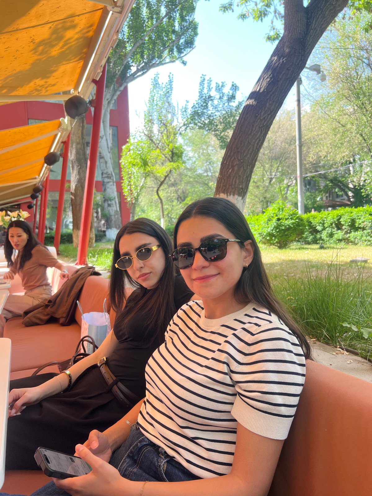 Midday cafe scene: patrons dining, socializing outdoors