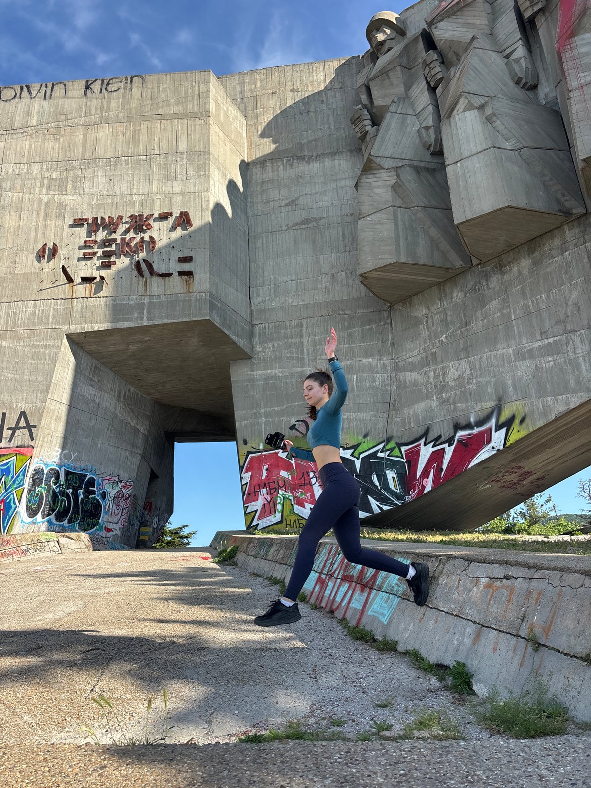 Woman performs fitness routine near monuments in Varna, Bulgaria