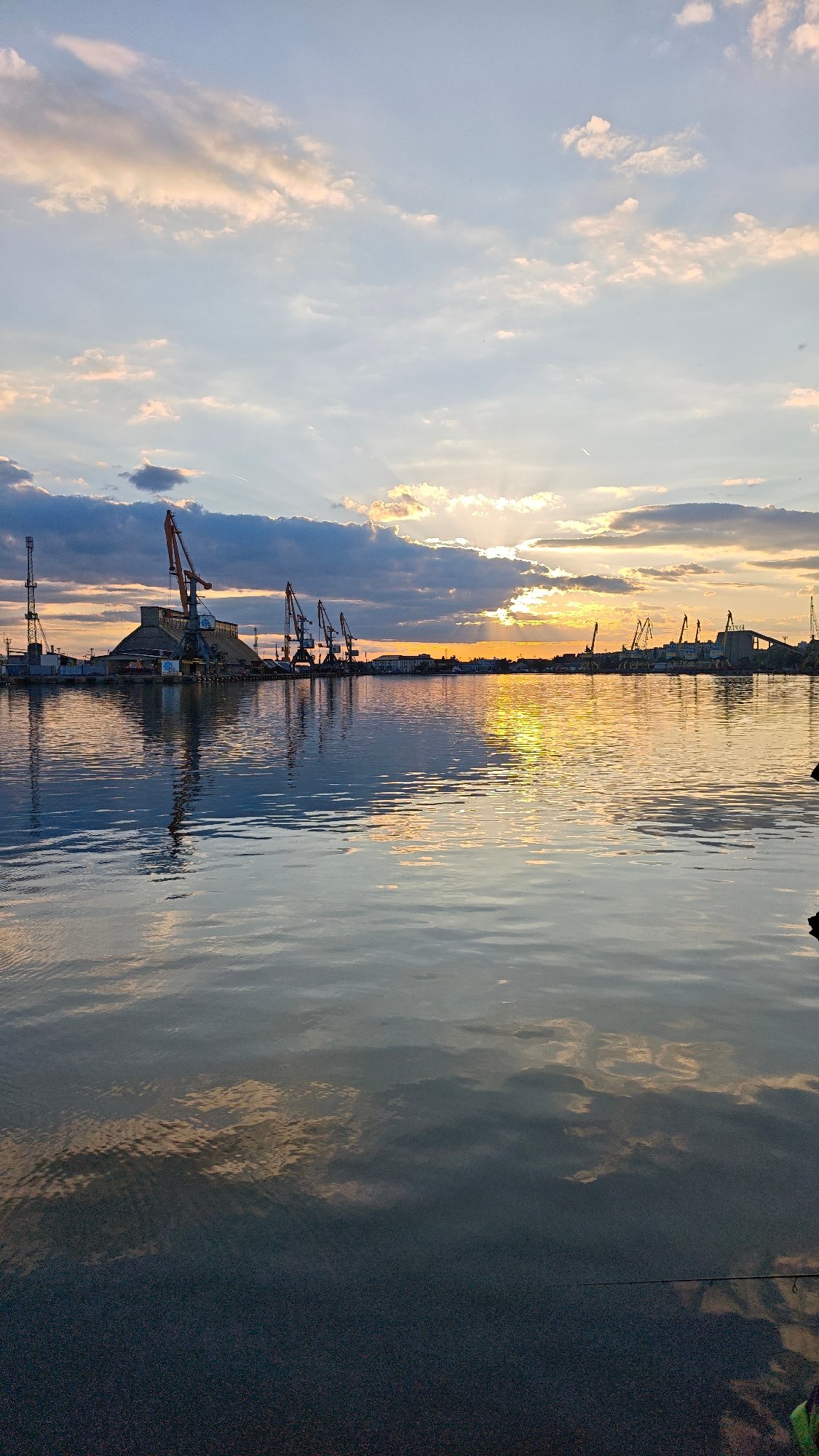 Evening fishing session at Burgas harbor during sunset